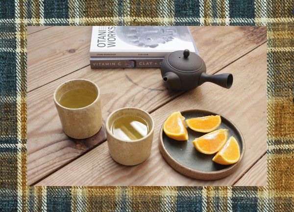 Honey Wood tumblers, teapot, books, fruit on plate